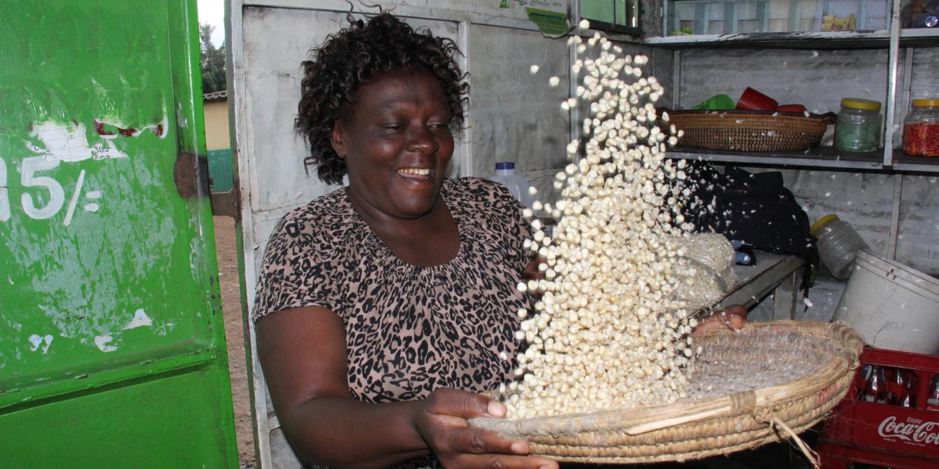 Small scale trader in Kibera market in Nairobi cleaning maize grains for sale in her small kiosk. Photo Credit: Benson Guantai Small scale trader in Kibera market in Nairobi cleaning maize grains for sale in her small kiosk. Photo Credit: Benson Guantai